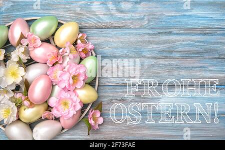 Easter eggs decoration with spring flowers. Happy Easter in German Stock Photo