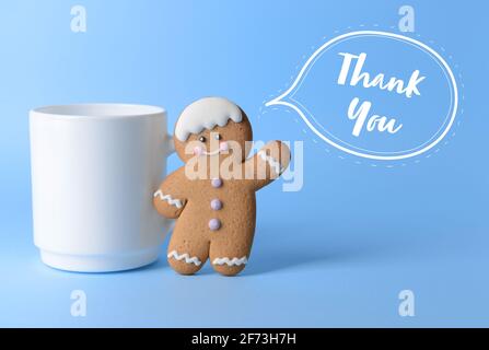 Cup with cookie on color background. Friendship Day celebration Stock Photo