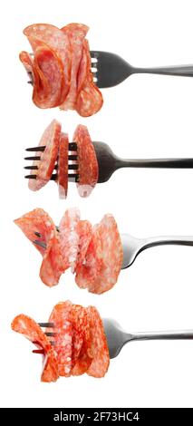 Forks with impaled slices of tasty smoked sausages on white background Stock Photo
