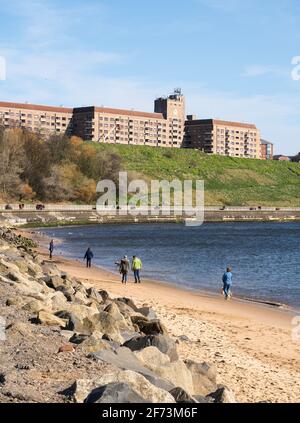 People walking along the Riverside path and on the Quayside sands in North Shields, northern England UK Stock Photo
