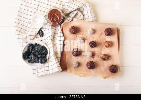Board with sweet chocolate candies on light background Stock Photo