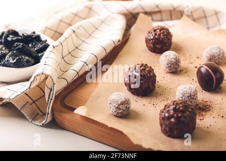 Board with sweet chocolate candies on light background Stock Photo