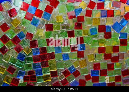 Red, blue, yellow and green transparant tiles on a glass window Stock Photo