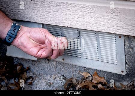 Aluminum vent door flap opened by the owner Stock Photo