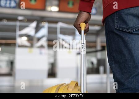 Close up African man hand touching baggage for check in at counter in airport Stock Photo