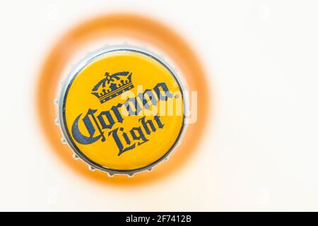 Calgary, Alberta, Canada. March 3, 2021. Top view of a corona light beer cap bottle on a white background. Stock Photo