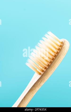 Bamboo toothbrush close up on blue background Stock Photo