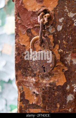 old lock on a rusty door in an abandoned building Stock Photo