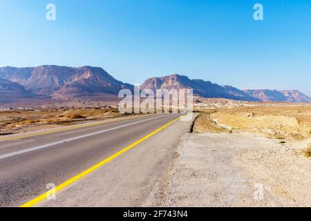 long road through the desert on a bright Sunny day Stock Photo