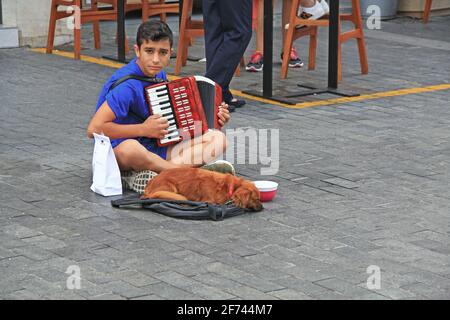 Young Musician and His Dog in Heraklion, Crete, Greece Stock Photo