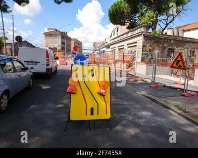 Rome, Italy - August 18, 2019: Road under reconstruction warning traffic sign, detour on city streets Stock Photo