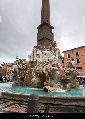 Rome, Italy - August 18, 2019: Bernini's Fountain of the Four Rivers with Obelisco Agonale, ancient obelisk in the center, close-up on cloudy day Stock Photo