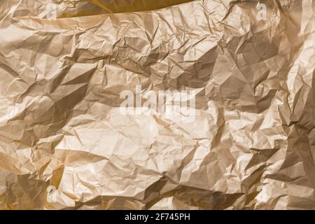 Abstract background texture golden shiny creased foil metal sheet Stock Photo