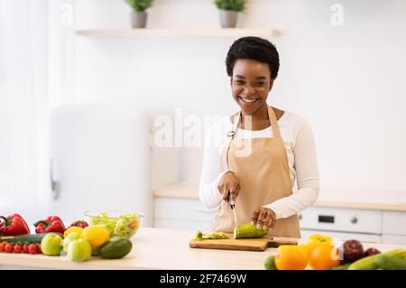 Woman cutting vegetables in the kitchen. Cooking healthy diet food concept  Stock Photo - Alamy