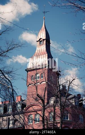 An old brick tower against blue spring sky in university town of Lund Sweden Stock Photo
