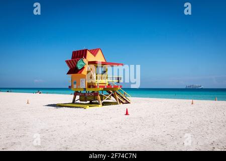 An orange and red lifeguard tower on a quiet day at the beach, on South Beach, Miami Beach, Florida Stock Photo
