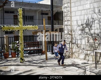 Palestinian Christian children are seen playing at the entrance to the Roman Catholic Church of the Holy Family during the Easter Mass.Easter Vigil, also called the Paschal Vigil or the Great Vigil of Easter, is a liturgy held in traditional Christian churches as the first official celebration of the Resurrection of Jesus. Historically, it is during this liturgy that people are baptized and that adult catechumens are received into full communion with the Church. It is held in the hours of darkness between sunset on Holy Saturday and sunrise on Easter Day most commonly in the evening of Holy Sa Stock Photo