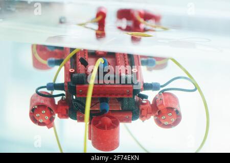 Close up background image of red robotic boat with camera in water tank at engineering and robotics laboratory, copy space Stock Photo