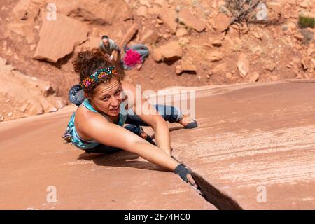 Female Rock Climber Makes Her Way Up a Crack System in Grand Junction, CO   4/26/20 Stock Photo
