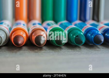 An even row of colored sided felt-tip pens on a sheet with space for writing and advertising Stock Photo