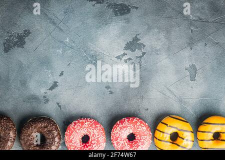 Glazed donuts set, on gray background, top view flat lay with copy space for text Stock Photo