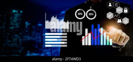 businessman touching digital business icon, graph and chart network connection on modern virtual interface. Stock Photo