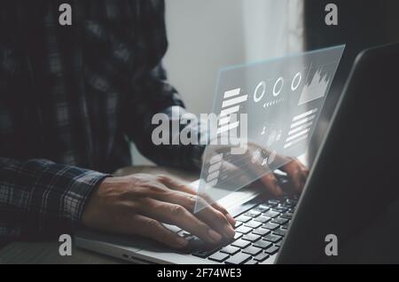 business man typing computer keyboard screen digital icon graph and chart. business on virtual screen and technology concept. Stock Photo
