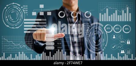 businessman touch screen digital icon graph and chart. business on virtual screen and technology concept. Stock Photo