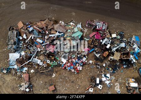 A pile of scrap metal on the ground top view. Secondary use of metal. Stock Photo