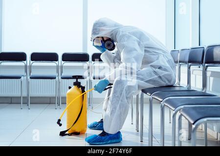 tired medical orderly in a biohazard suit. Stock Photo