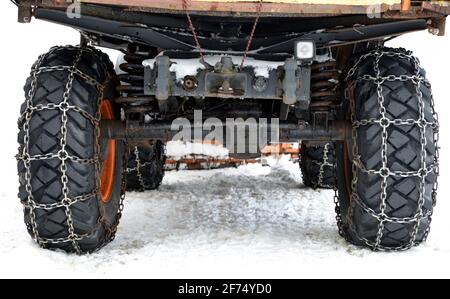 Car wheels equipped with snow chains. Stock Photo