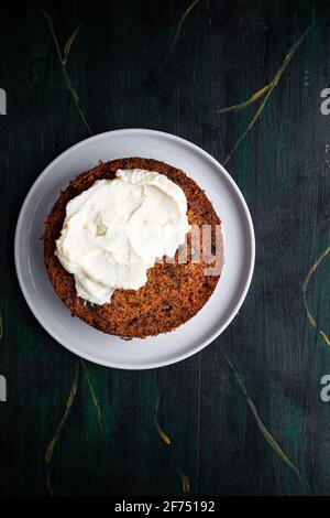 Overhead view of tasty soft cake biscuit on plate with spread cream on table Stock Photo