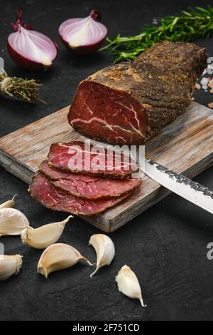Beef jerky on wooden cutting board Stock Photo