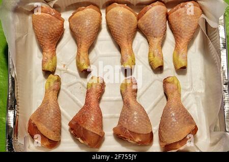two rows of raw chicken legs ready to cook Stock Photo