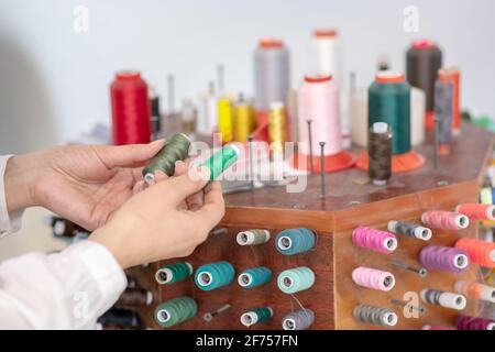 Female hands holding two skeins of thread Stock Photo