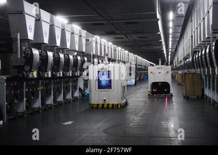 Huzhou, China's Zhejiang Province. 30th Mar, 2021. A 5G intelligent robot delivers textile products at a workshop of Xinfengming Group in Huzhou City, east China's Zhejiang Province, March 30, 2021. Credit: Xu Yu/Xinhua/Alamy Live News Stock Photo