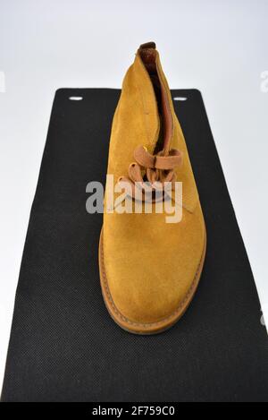 Casual, universal ordinary shoes for a daily walk. Brown half boots, shoes on a wide beige cachic sole. Footwear made of genuine leather, natural. Stock Photo