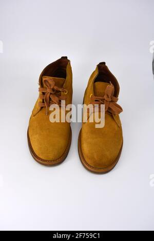 Casual, universal ordinary shoes for a daily walk. Brown half boots, shoes on a wide beige cachic sole. Footwear made of genuine leather, natural. Stock Photo