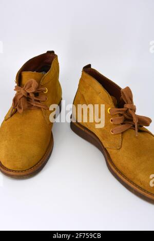 Casual, universal ordinary shoes for a daily walk. Brown half boots, shoes on a wide beige cachic sole. Footwear made of genuine leather, natural. Stock Photo