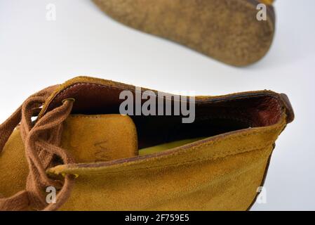 Casual, universal ordinary shoes for a daily walk. Brown half boots, shoes on a wide beige cachic sole. Footwear made of genuine leather, natural. Stock Photo
