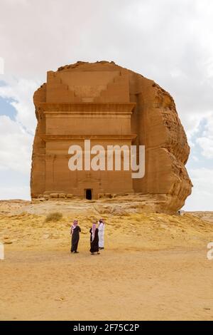 AlUla, Saudi Arabia, February 19 2020: Tourists from Saudi Arabia stand with ther guides in front of the tomb of Lihyan son of Kuza, known as Qasr AlF Stock Photo