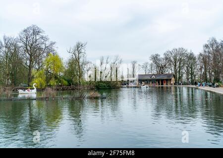 LONDON, UK - MARCH 31 2021: View of boating lake with Lakeside Café and pedal boats on at Alexandra Palace in London Stock Photo