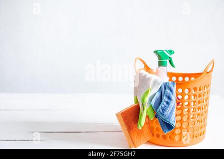 Close up set of home cleaning products in a bright basket. Means for maintaining cleanliness. Stock Photo