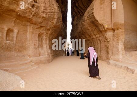 Al Ula, Saudi Arabia, February 19 2020: Tourists inside the Siq of Jabal Ithlib in Al Ula, KSA Stock Photo