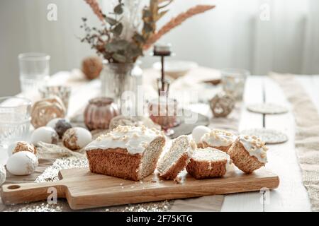 A festive table with a beautiful setting and freshly baked Easter cake. Stock Photo