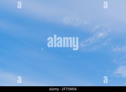 Abstract template with blue sky, white clouds and waxing half moon. Beauty of nature concept. Abstract natural background. Stock Photo