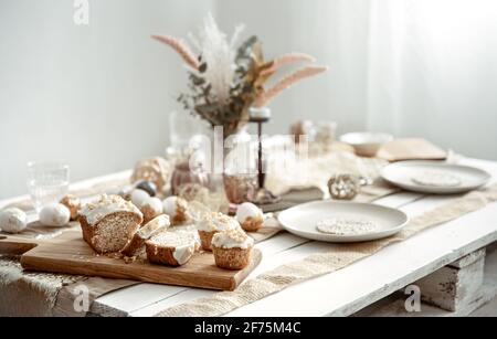 A festive table with a beautiful setting and freshly baked Easter pastries. Stock Photo