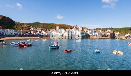 Sunny summer view across the harbour towards the attractive fishing village of Staithes on the Yorkshire coast Stock Photo