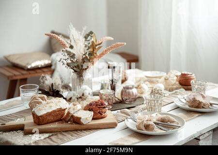 A festive table with a beautiful setting and freshly baked Easter pastries. Stock Photo