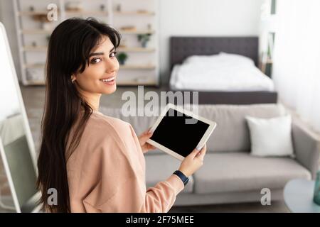 Woman using digital tablet with blank empty screen, mockup Stock Photo